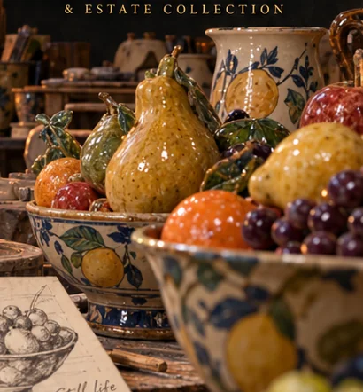 Imagined glazed ceramic fruit, including pears and oranges, in handmade bowls
