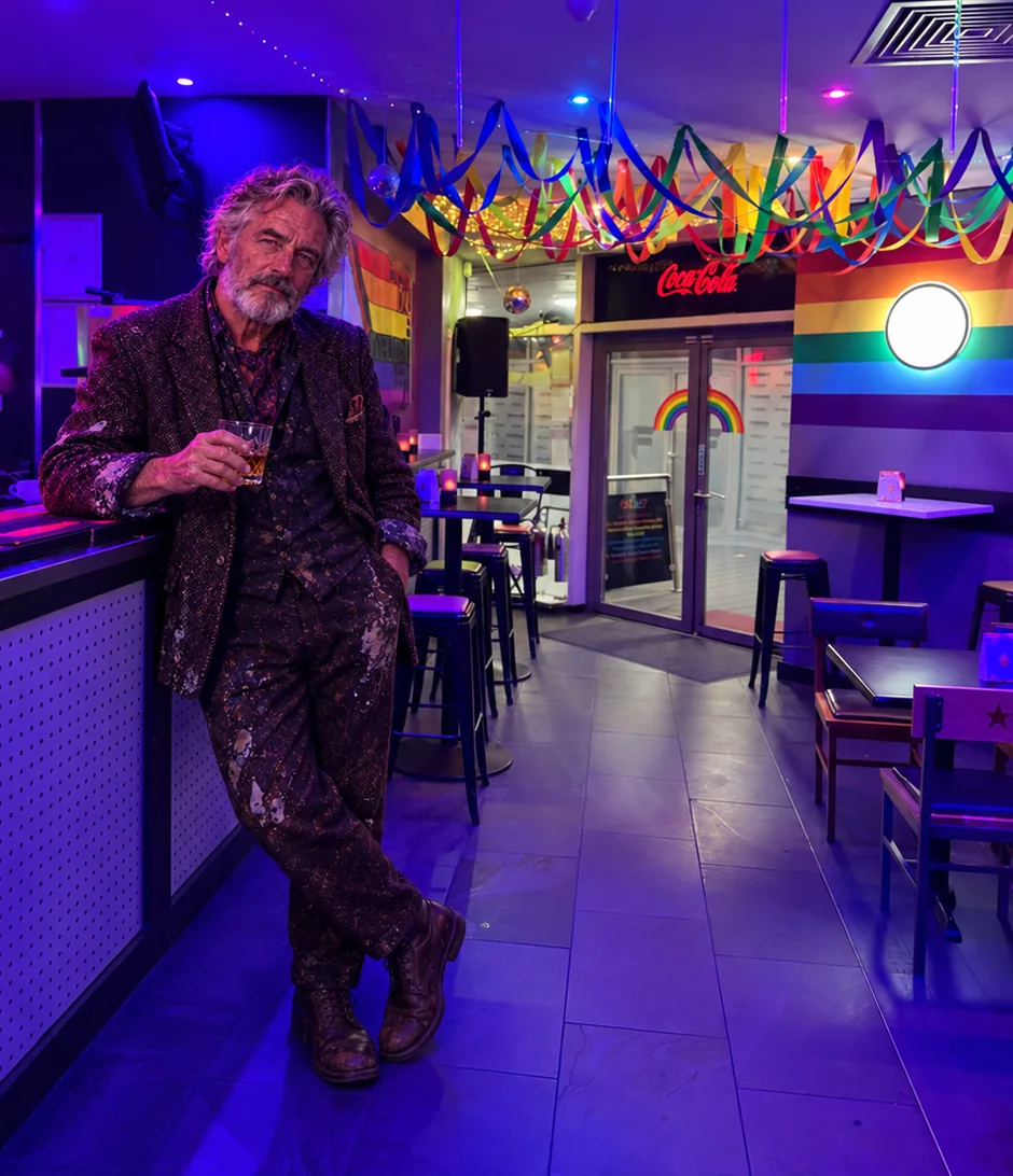 AI-created composite showing the fictional Harry Bellgate leaning against the counter of a Glasgow bar decorated with rainbow streamers